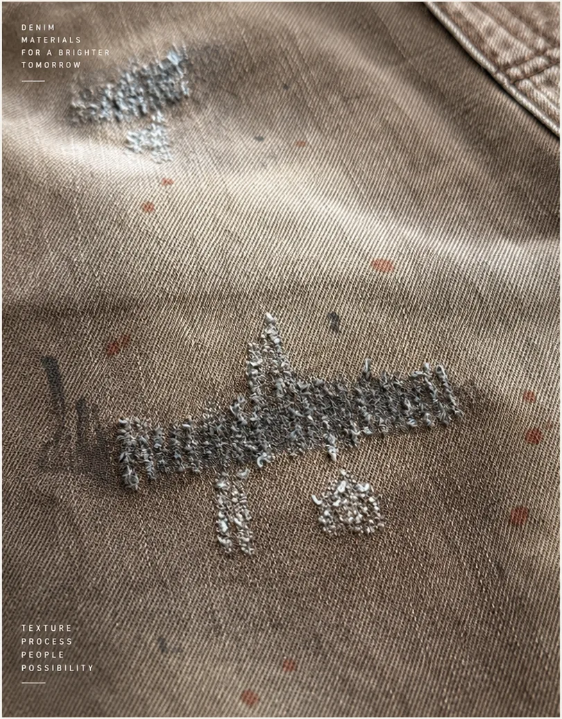 Detail study of a dusted denim surface with soft abrasion and irregular tonal marking.