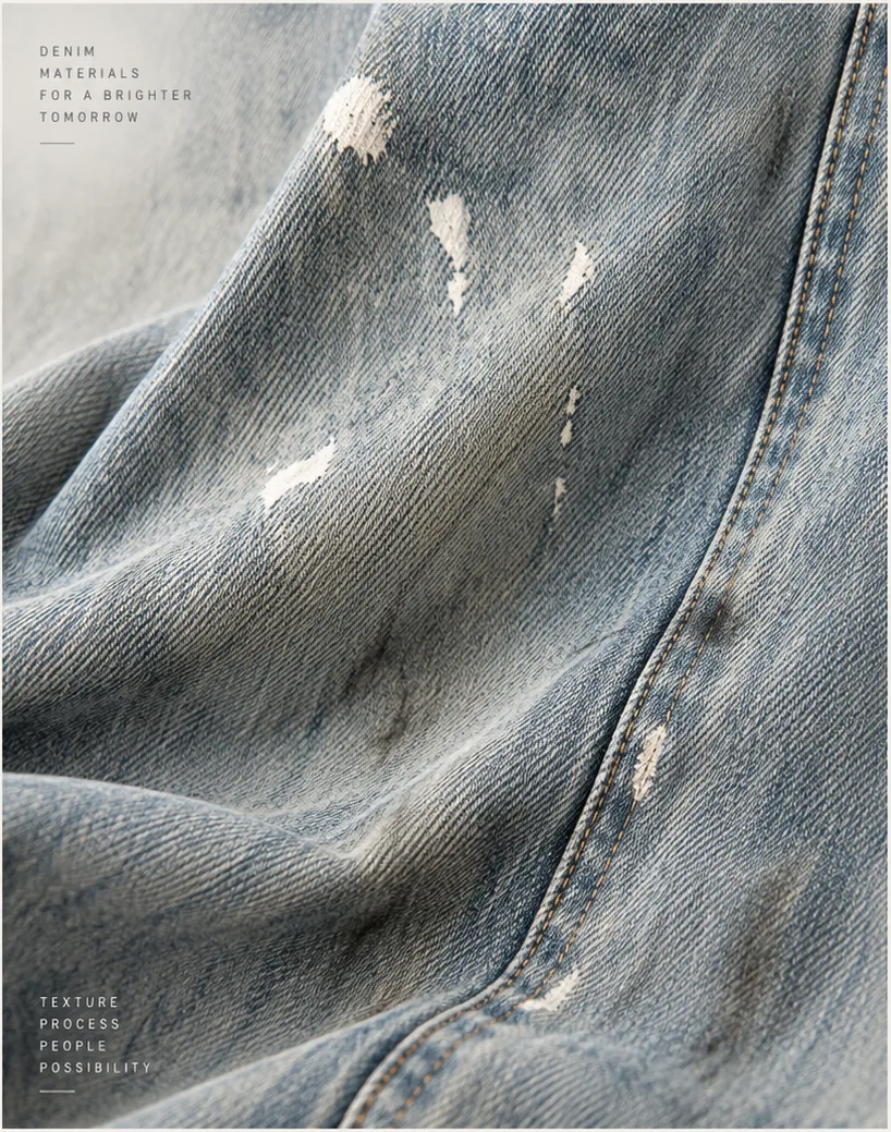 Detail study of a faded vintage blue denim surface with graphic print detail.