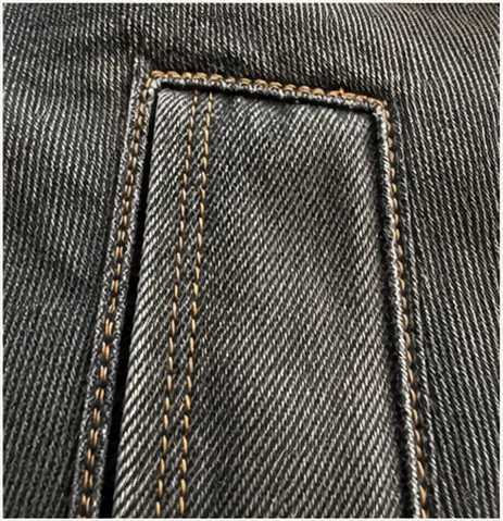 Detail of charcoal denim twill and contrast stitching.